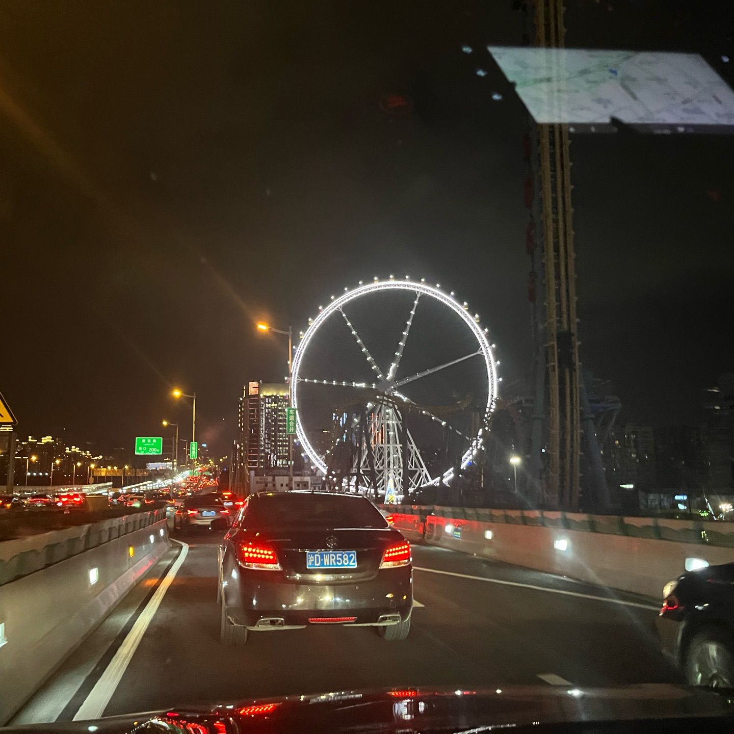 A amazing sparking Ferris wheel on the roadside , on the rainy night of Valentine's Day