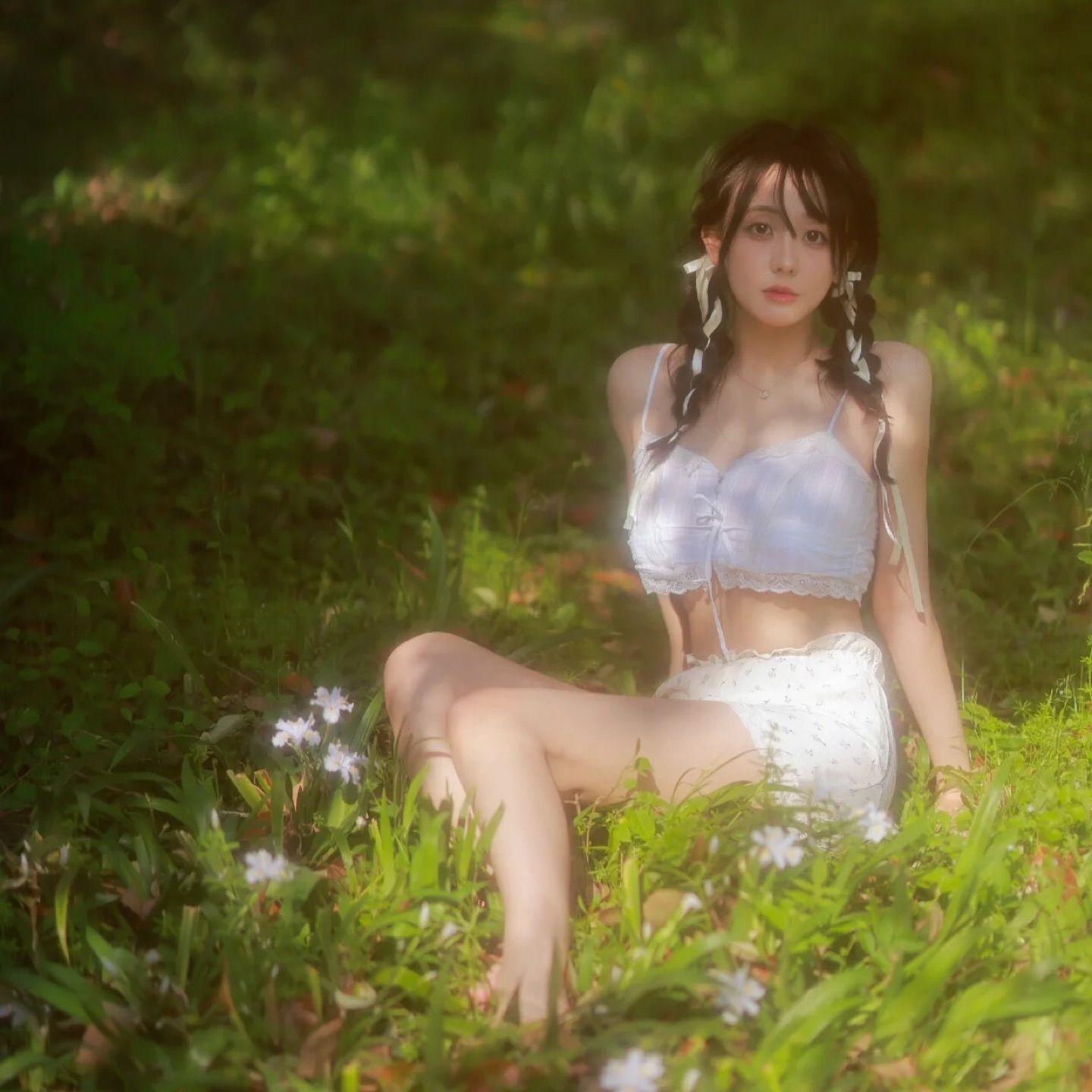 A beautiful woman sitting on the grass