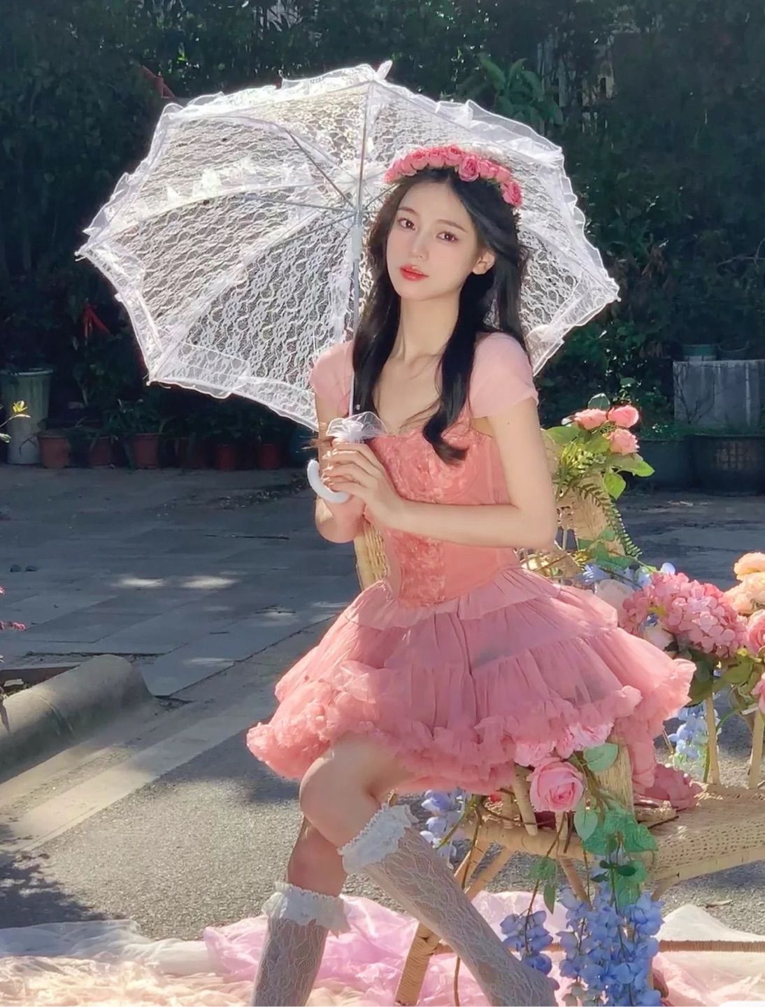 The pink girl holds an umbrella