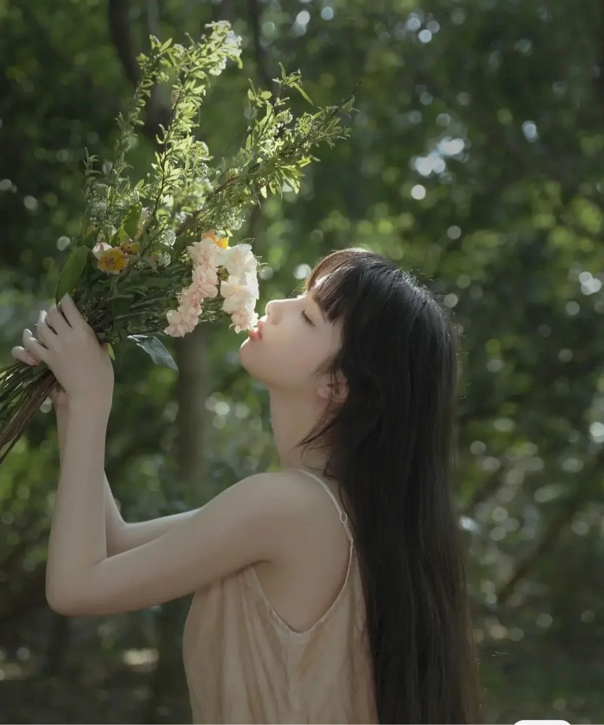 The dog is smelling the flowers